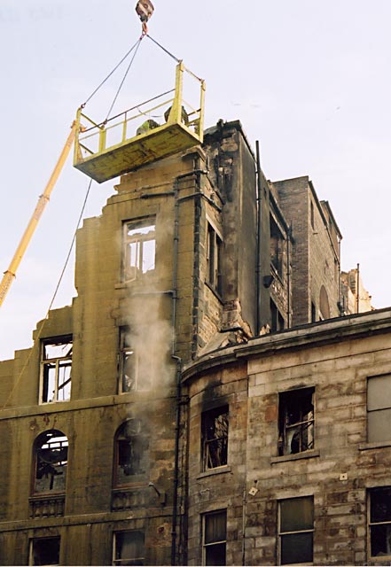 Photograph by Peter Stubbs  -  Edinburgh  -  December 2002  -  Fire in the Old Town of Edinburgh  -  Dismantling the wall in the Old Town of Edinburgh (close-up)
