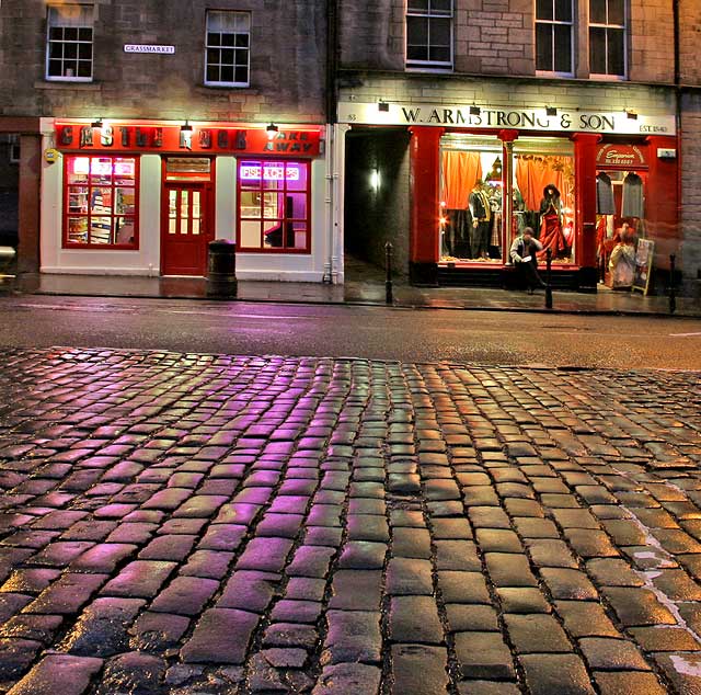 Looking from the foot of West Bow across the cobbles to the shops on the south side of the Grassmarket