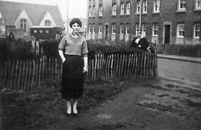 Dave Ferguson's daughter, Janet, standing outside No.1 Hay Drive, Niddrie