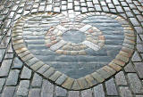 The Heart of Midlothian , set in the cobbles near the NW corner of St Giles Church in High Street, Edinburgh