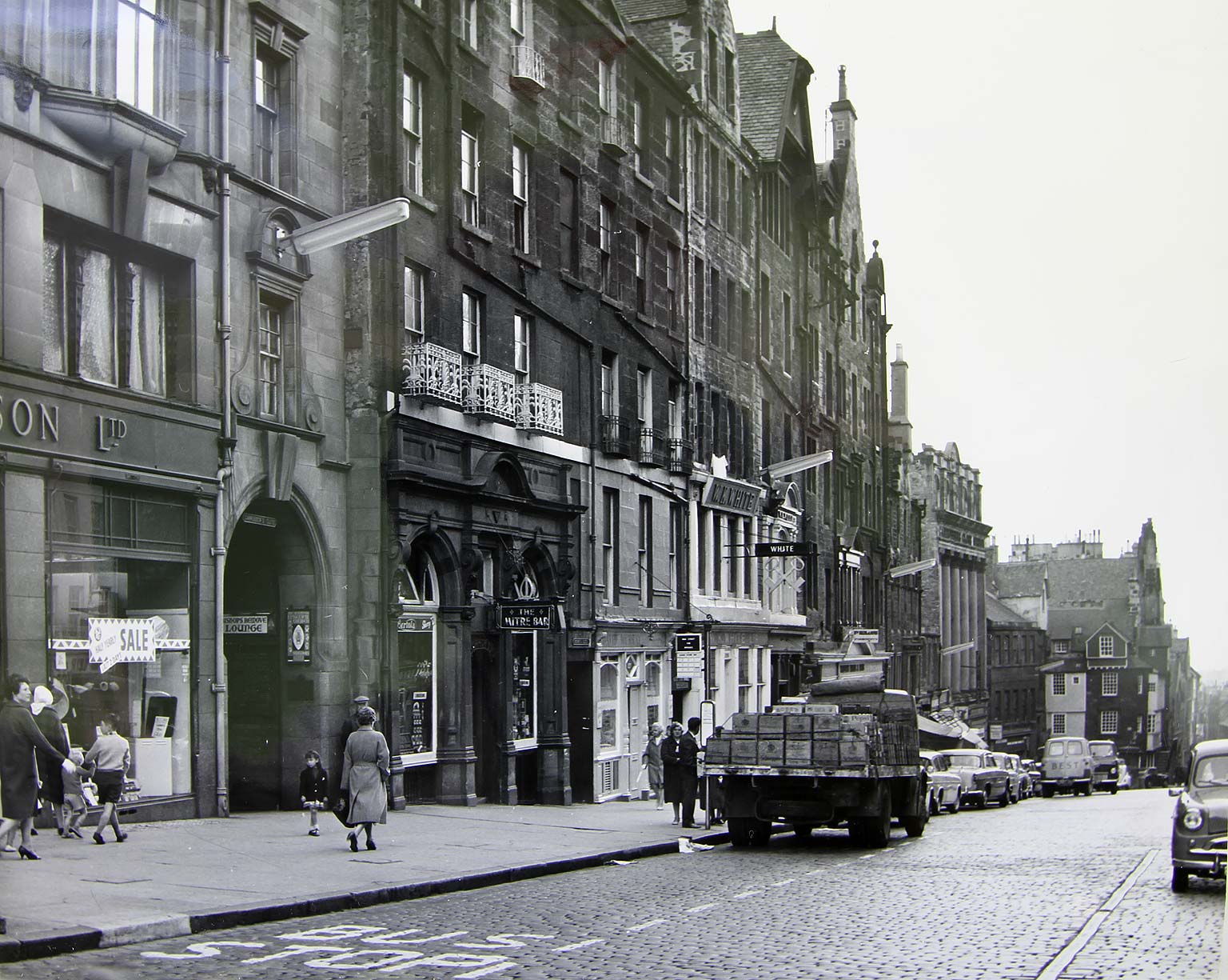 High Street  -  looking to the east from the junction with South Bridge.  Street lights are mounted on the wall
