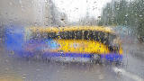 Photo taken in the rain from the front seat on the upper deck of a Lothian Bus  -  Citylink Coach turning from Frederick Street into Princes Street