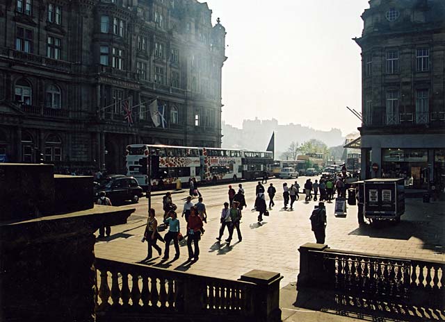 View looking towards Edinburgh Castle with pedestrians at the East End of Princes Street in the foreground