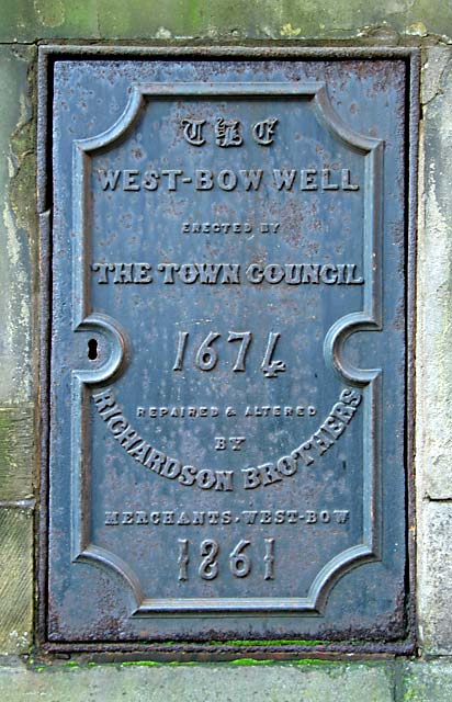 A sign on a small door on the western side of West Bow Well
